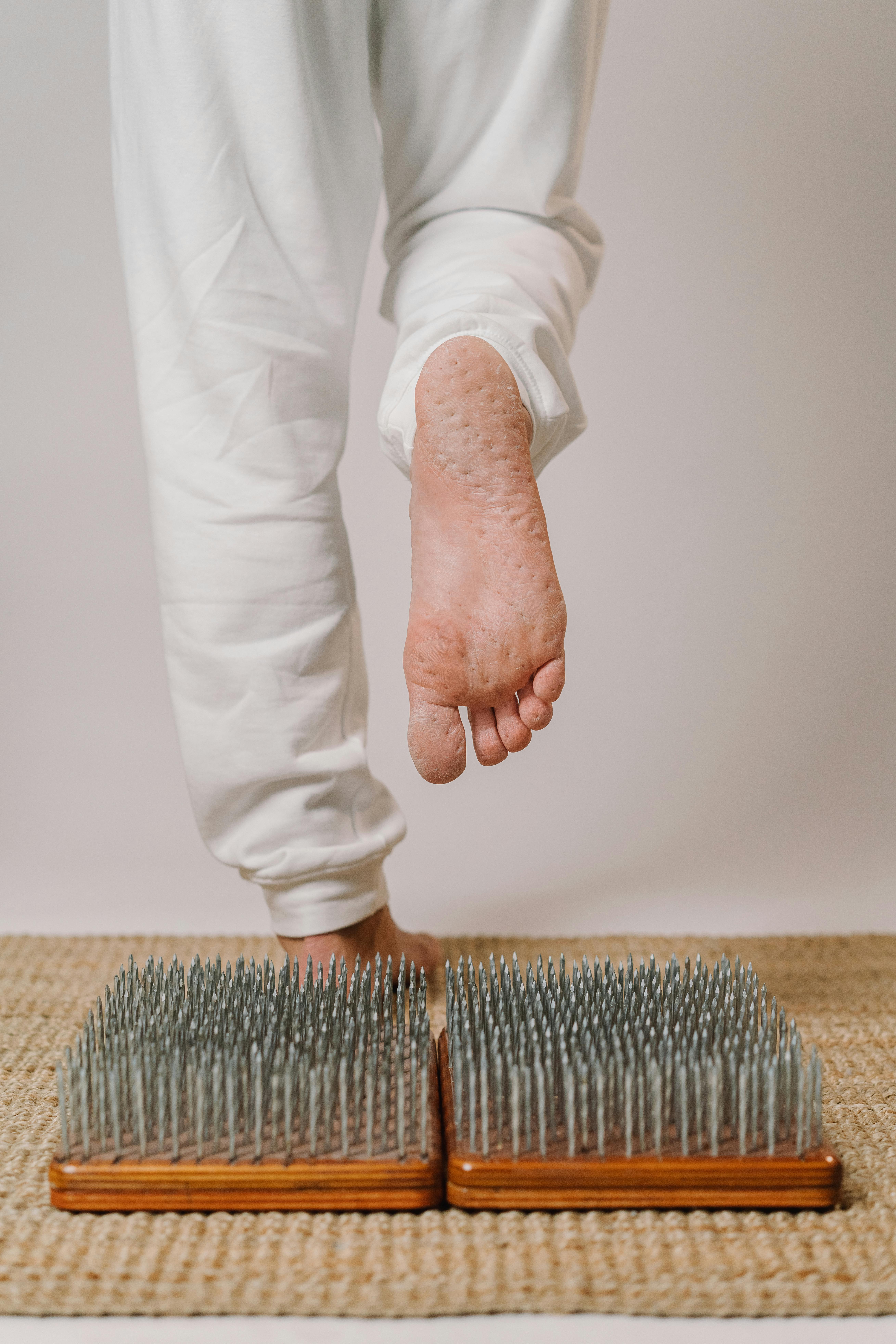 Image of the bottom of a foot that has just stepped off a bed of nails